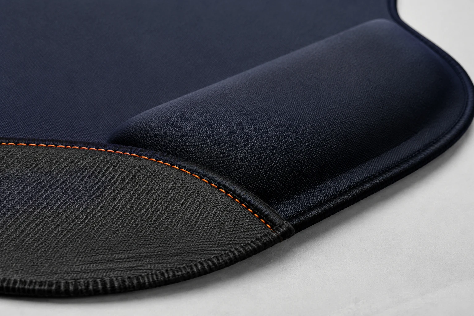 Fabric surface, soft wrist cushion and stitched edge detail on a custom wrist rest mouse pad
